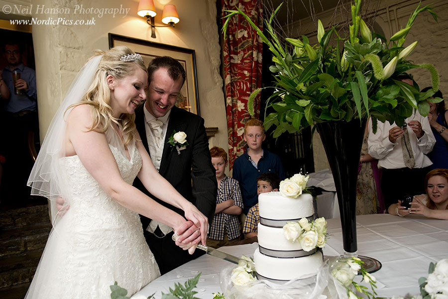 Bride & Groom cutting their Wedding Cake at The Bay Tree Hotel