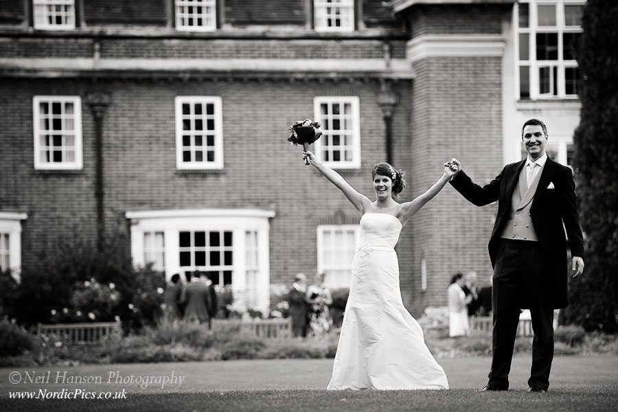 Bride and Groom celebrating their wedding at St Hughs College Oxford