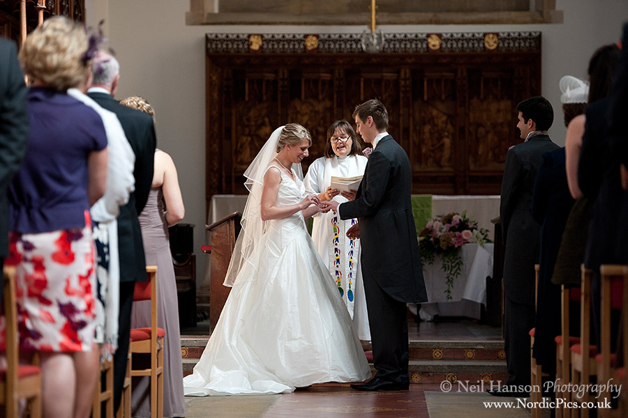 Bride & Groom exchange rings at a wedding ceremony at St Peters College Chapel Oxford