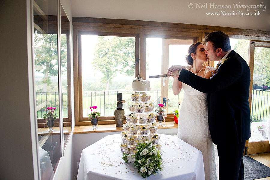 Bride & Groom cutting their Wedding cake at The Feathered Nest Country Inn at Nether Westcote