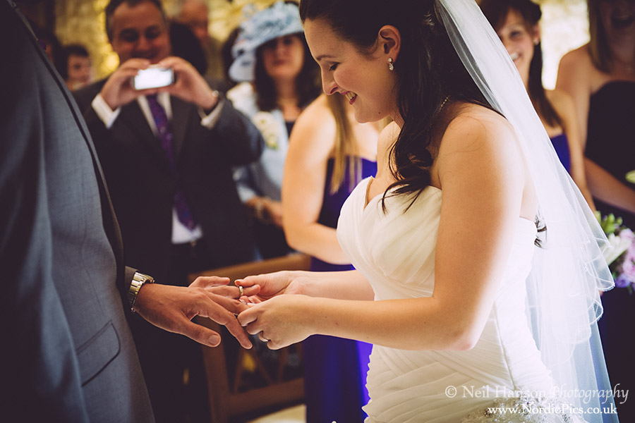 Bride & Groom exchange rings at a Wedding at Caswell House
