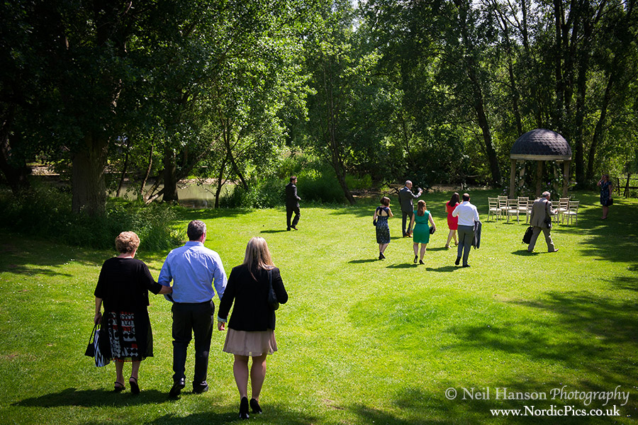 Guests arriving for a garden temple wedding ceremony at The Old Swan and Minster Mill