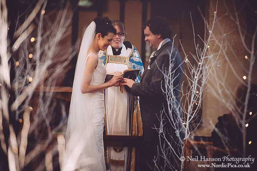 Bride & Groom exchanging rings at a Winter Wedding at St Marys Church Kidlington in Oxfordshire
