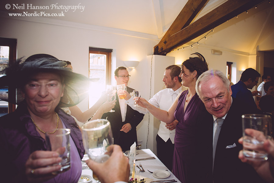 Toast to the bride and groom after their Wedding at The Divinity School in Oxford