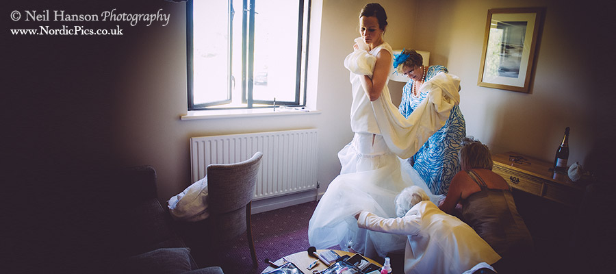 Bride getting into her Wedding Dress at The Thames Four Pillars Hotel in oxford