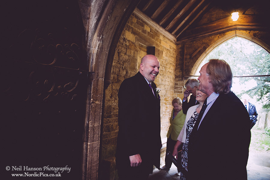 Groom greeting the guests at St Marys Church Adderbury