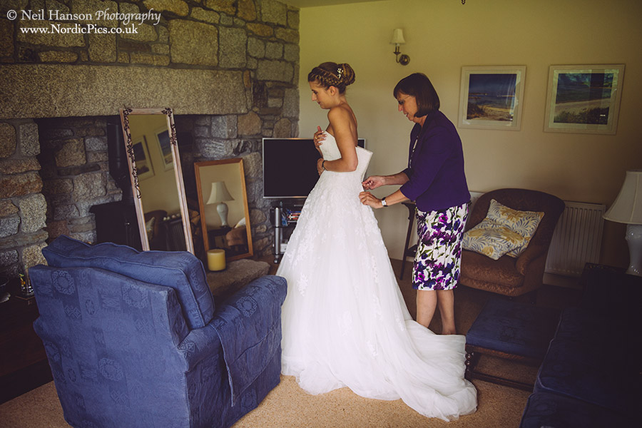 Sara putting on her Wedding dress before the ceremony at St Breward Church Bodmin