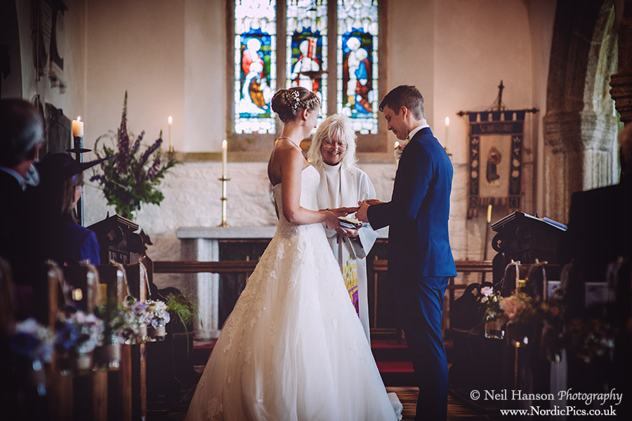Bride & Groom exchanging rings at St Breward Church Wedding