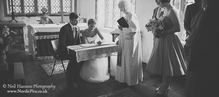 Bride & Groom sign the register at St Breward Church