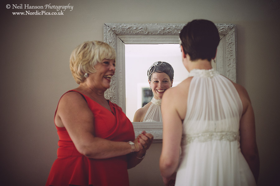 Bride looking in the mirror for final preparations