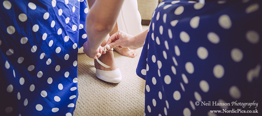 Bride putting on her wedding shoes at Rye Hill Golf Club