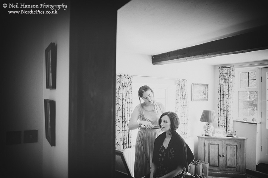 Hair and make-up preparations for the bride before her wedding at Penshurst Place in Kent