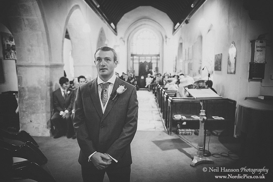 Nervous groom waits his bride at St Giles Church Horspath