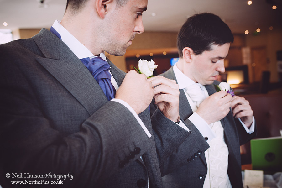 Boys putting on their buttonholes