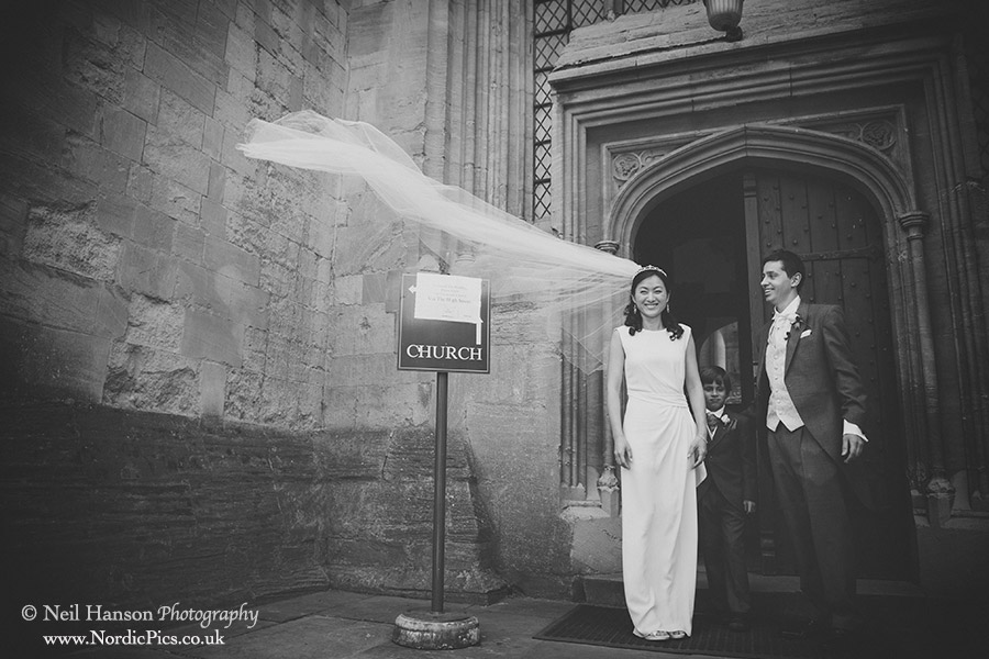 Brides veil blows in the wind at her Oxford Wedding