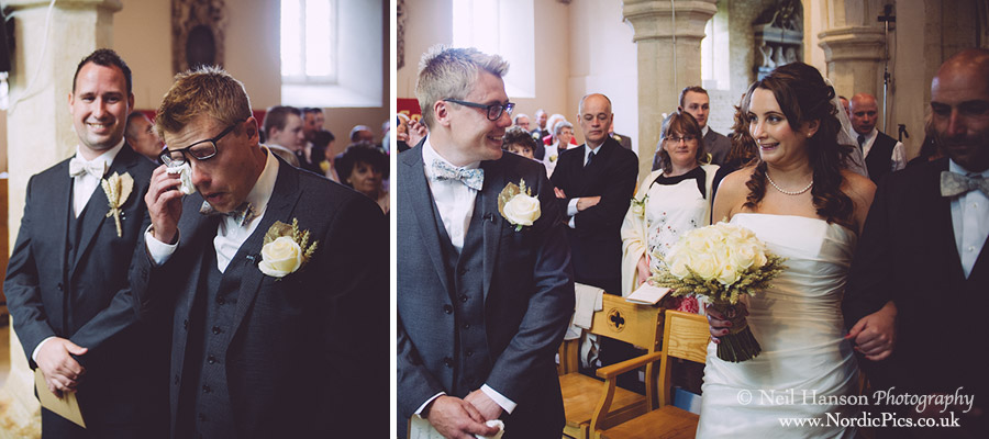 Emotional groom greets his bride at their Wedding at St Marys Church Cogges