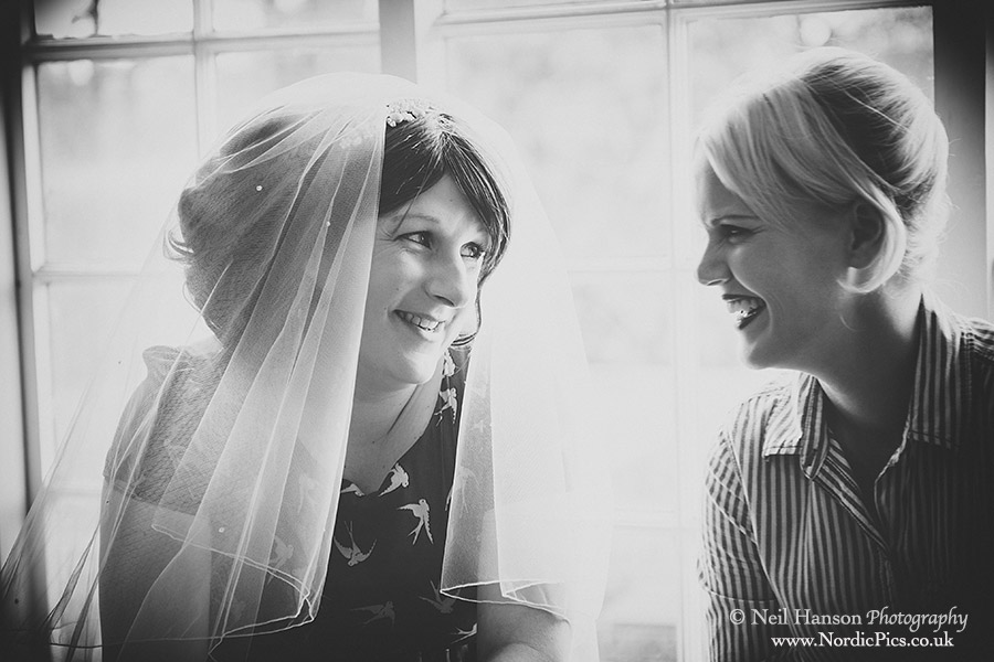 A touching moment between the bride & bridesmaid on a wedding day at Cripps Barn