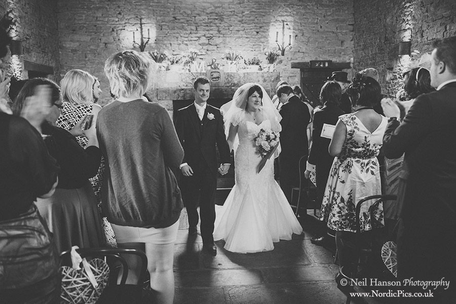 Bride & groom exit after the wedding ceremony at Cripps Barn