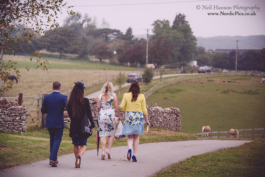 Wedding guests walk to they farm from the church