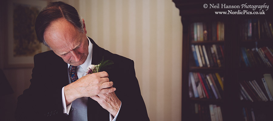 Grooms father puts on his buttonhole