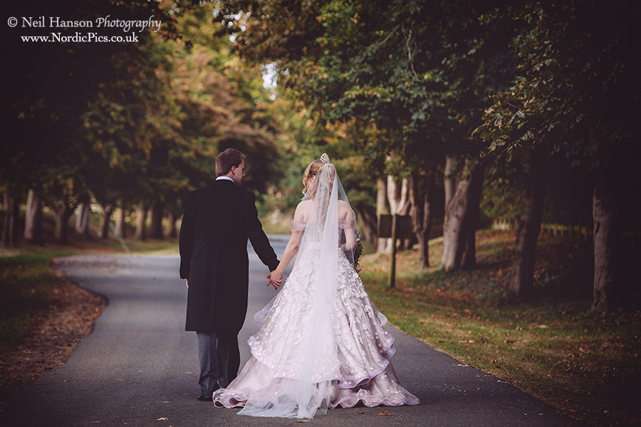 Bride & groom walk around the grounds of Worton Park in Oxfordshire