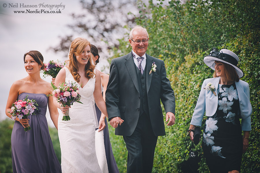 Bridal party walk to the outdoor Wedding ceremony at Caswell House
