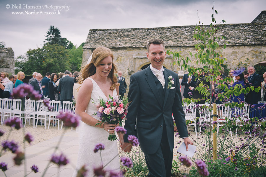 Bride & groom exiting their outdoor Wedding ceremony at Caswell House