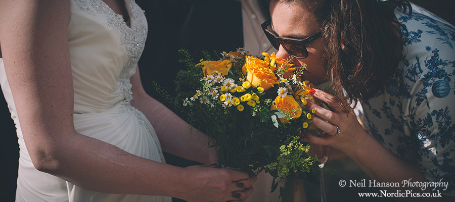 Guest smelling bride bouquet