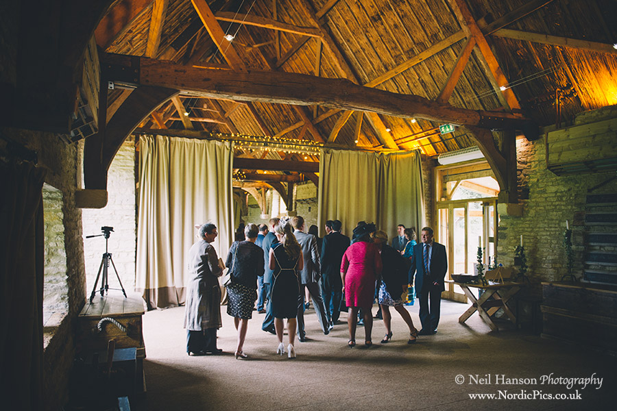 Guests waiting in the main barn for a wedding to start
