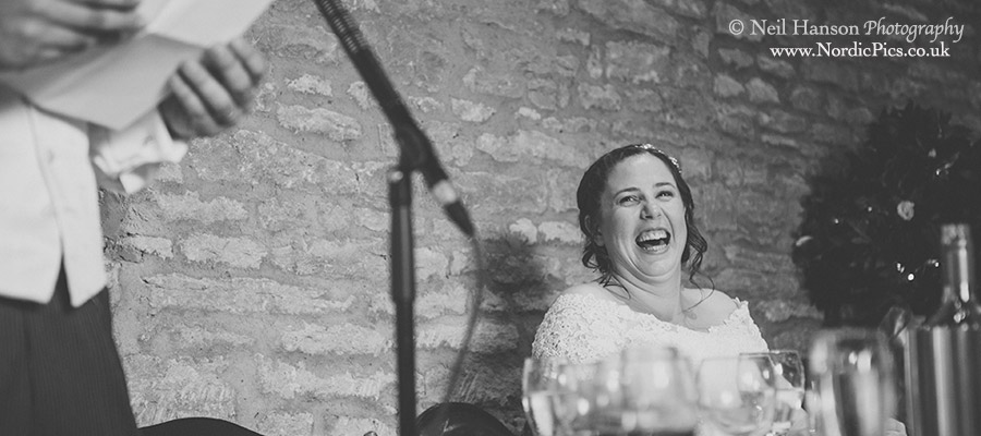 Brides laughter at the speeches at her Tythe Barn Wedding