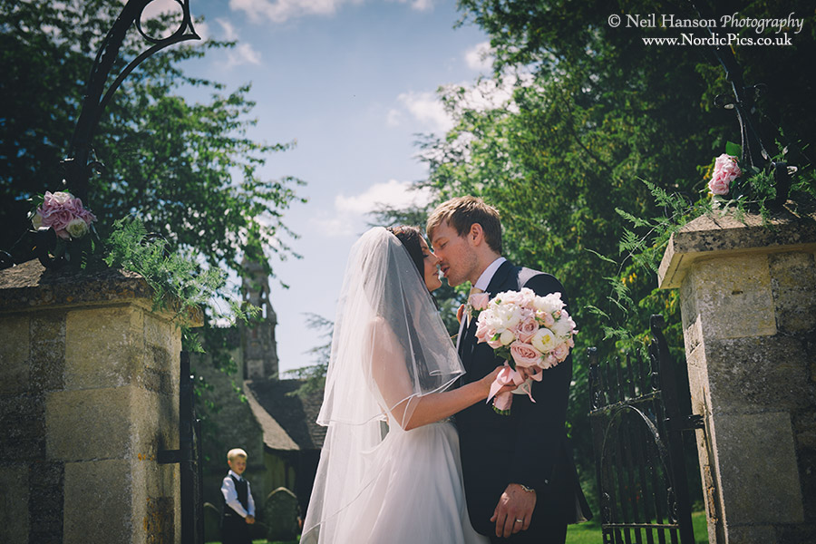 Bride & groom embrace outside Hailey church in Oxfordshire