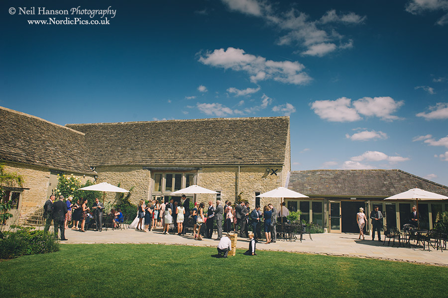 Guests enjoying a hot summer days wedding at Caswell House in Oxfordshire