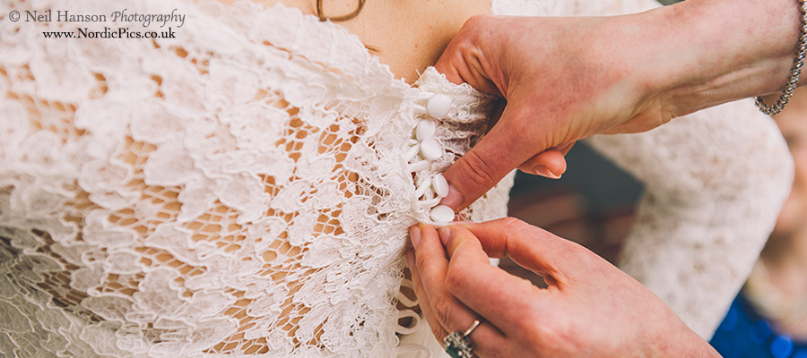 Brides dress being buttoned up