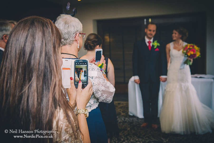 Guests taking photos of the bride & groom at a Milton Hill House Wedding
