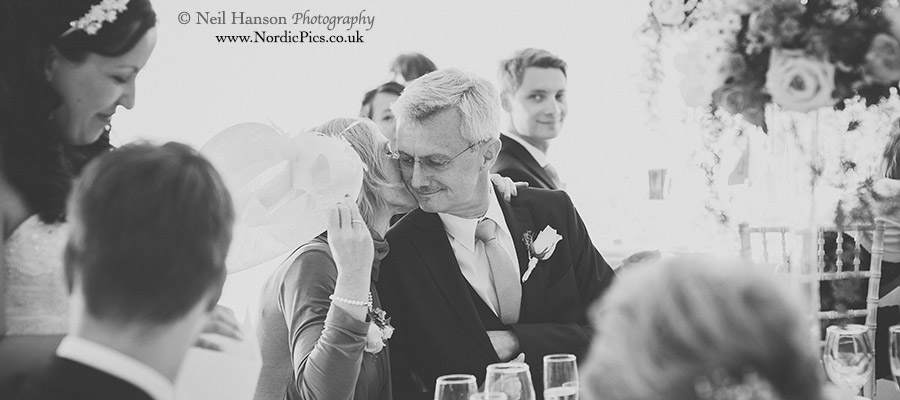 Father of groom embracing his wife