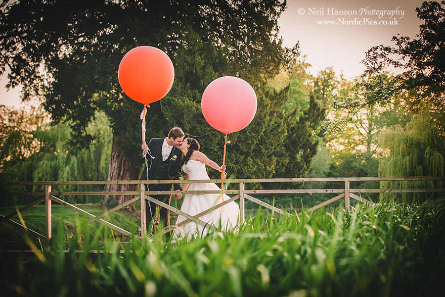 Bride and Groom with large balloons at an Ardington House Wedding
