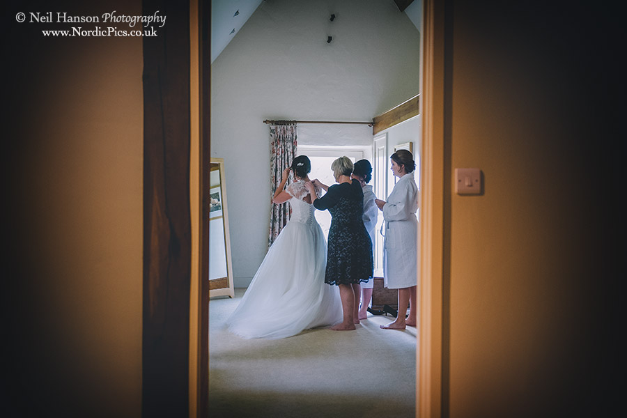 Bride putting on here Wedding Dress at Caswell House