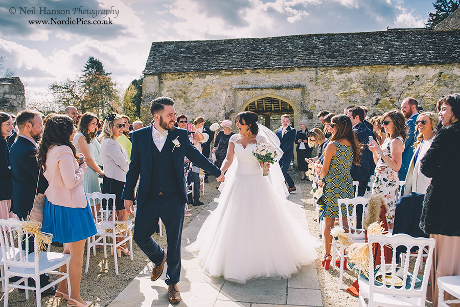 Bride and Groom exiting the outdoor Wedding ceremony at Caswell House