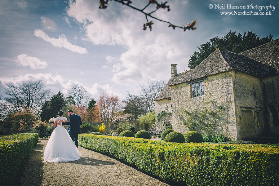 Bride and Groom walking around the grounds of Caswell House