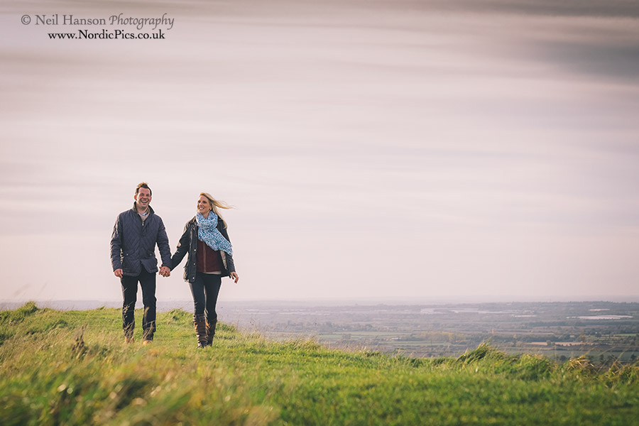 Couple walking at The White Horse Hill during their engagement portrait session