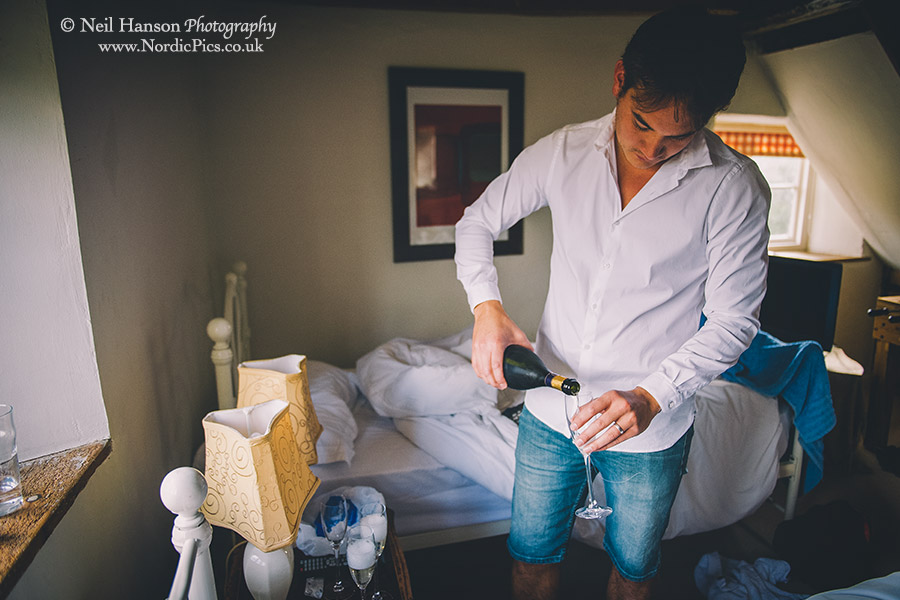 Groom pouring his morning champagne 
