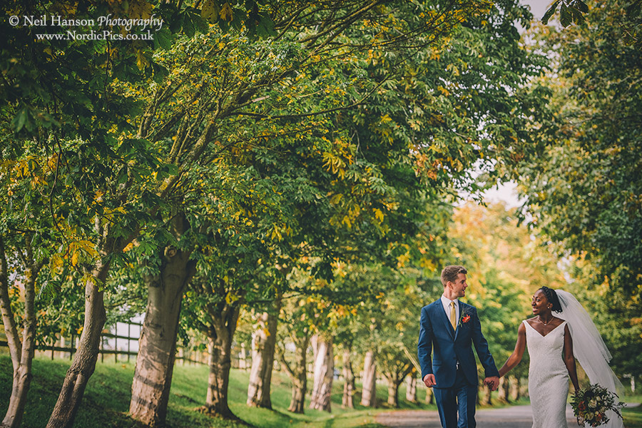 Bride and Groom walking in the grounds of Worton Hall