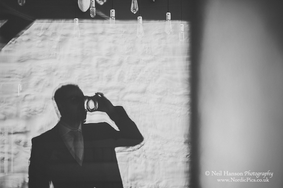 Groom finishing his drink before heading to the church on his wedding day