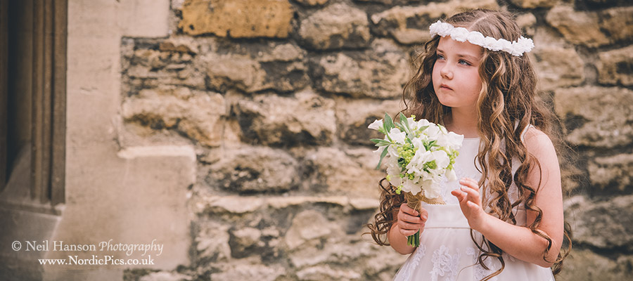 Flower girl waiting for the bride to arrive outside the church