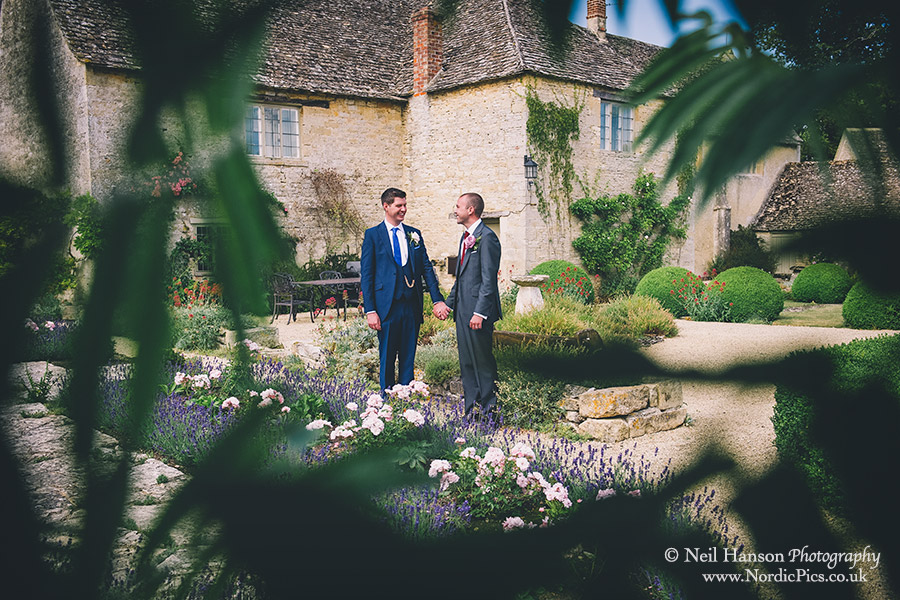 Grooms in the gardens of Caswell House on their same sex wedding day