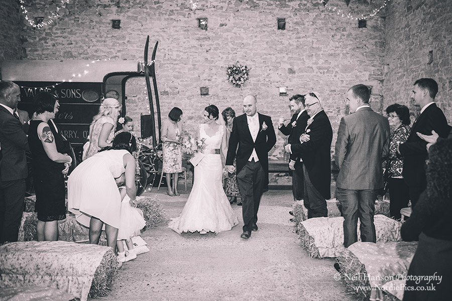 Bride and Groom walking down the isle after their wedding ceremony at Cogges Farm