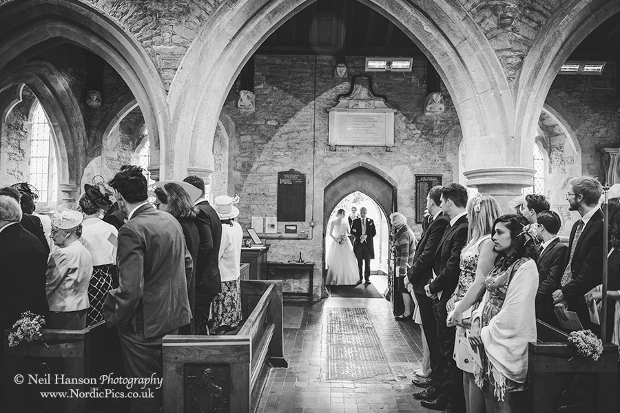 Bride and her father enter Standlake Church on her wedding day