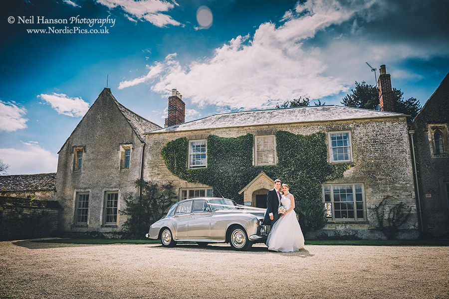 Bride and Groom with their Wedding Car at Caswell House