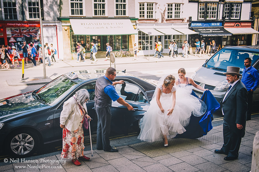 Bride arrives on her wedding day outside University College Oxford