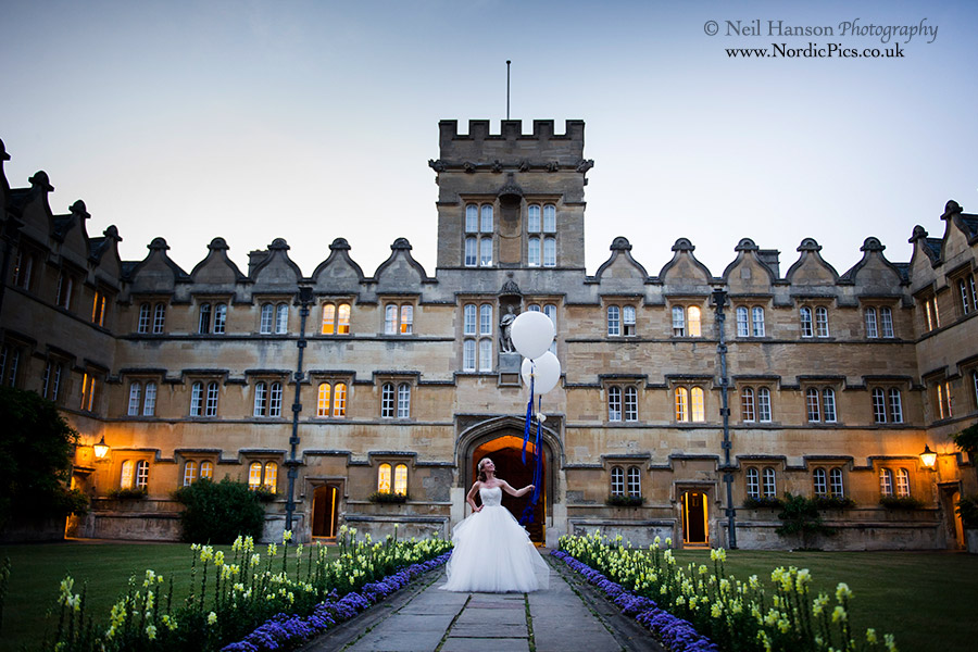Bride with large balloons at University College Oxford